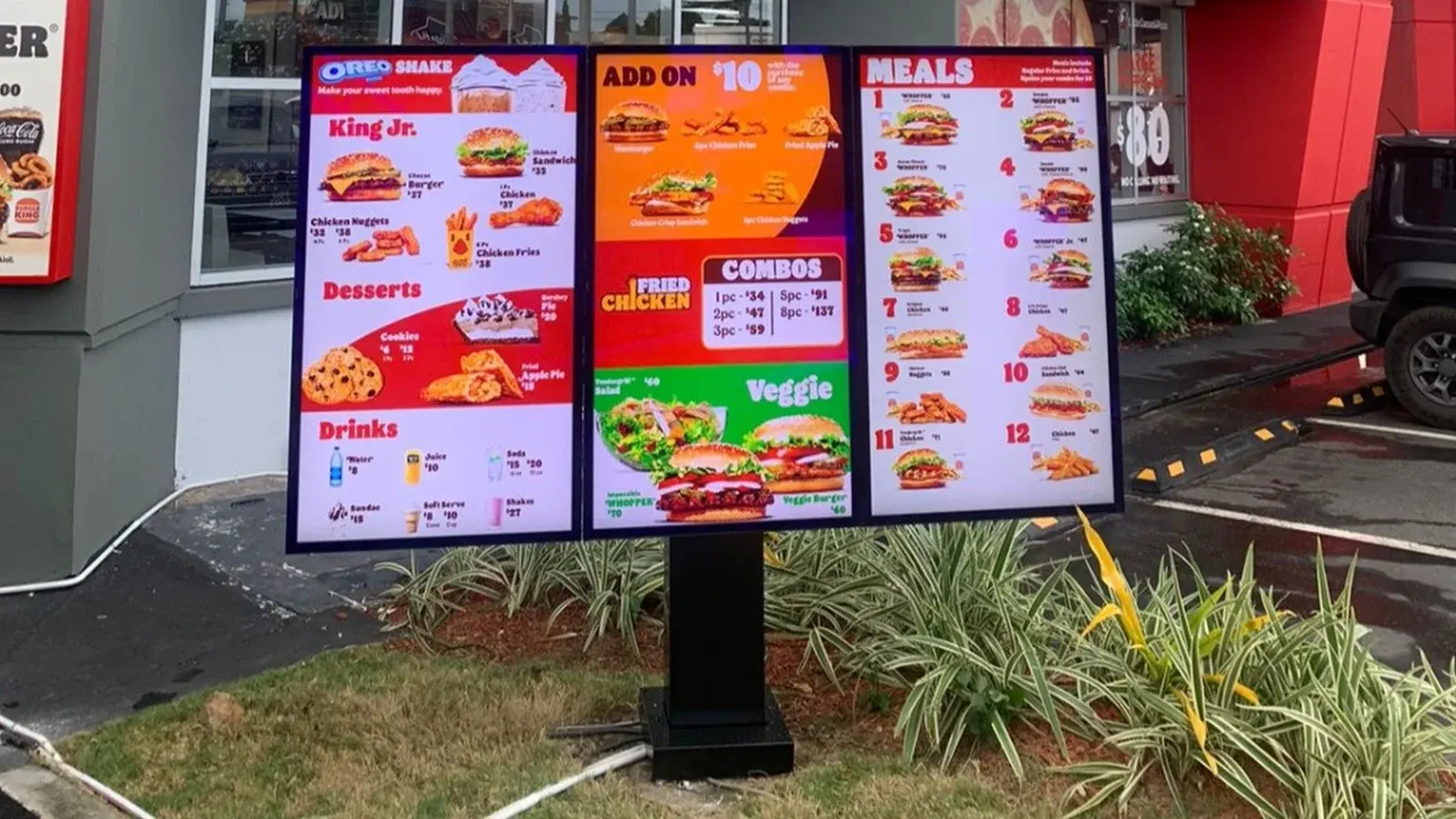 Triple-panel outdoor digital menu board installed at a Burger King drive-through