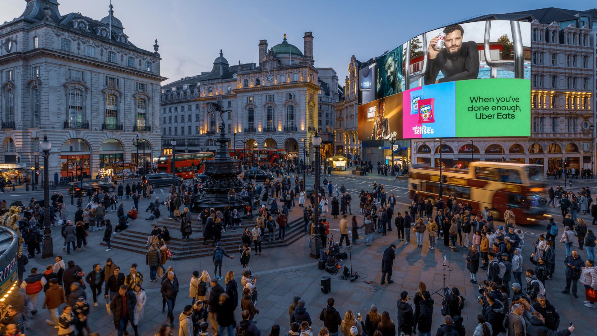 Piccadilly Lights curved digital billboard displaying its multi-brand patchwork above Piccadilly Circus in London